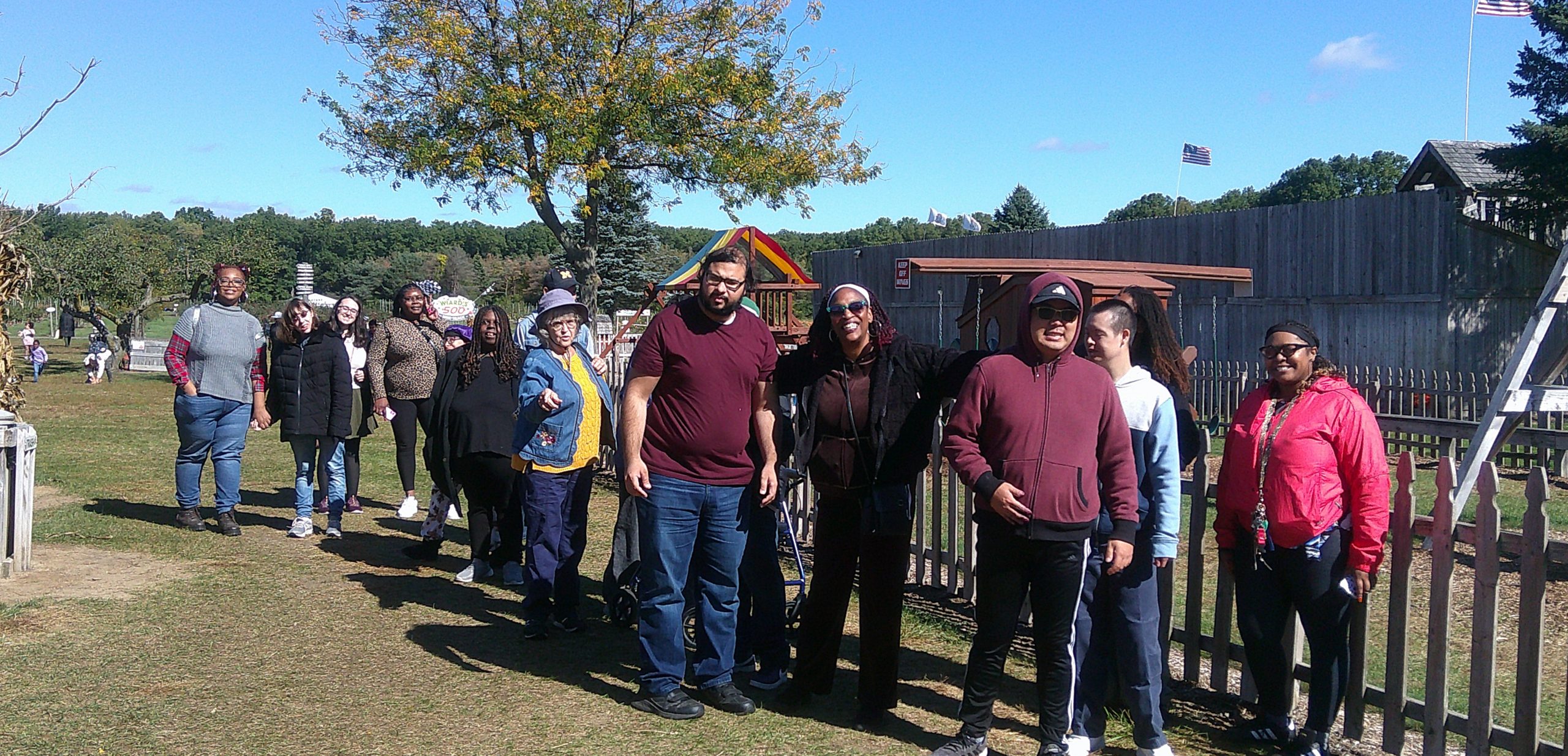 Continuum participants and staff gathered during an orchard visit